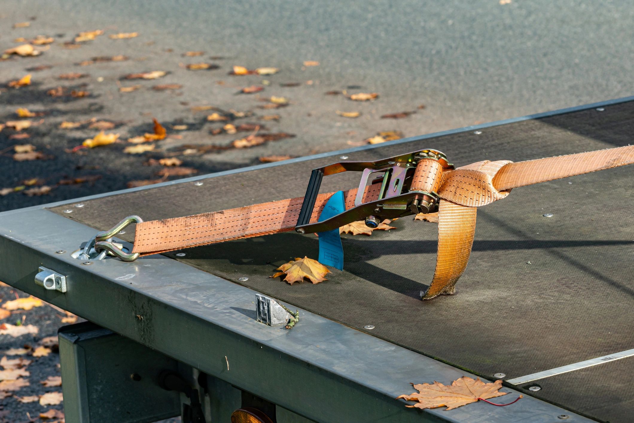 Close-up of a load securement strap on a flatbed trailer