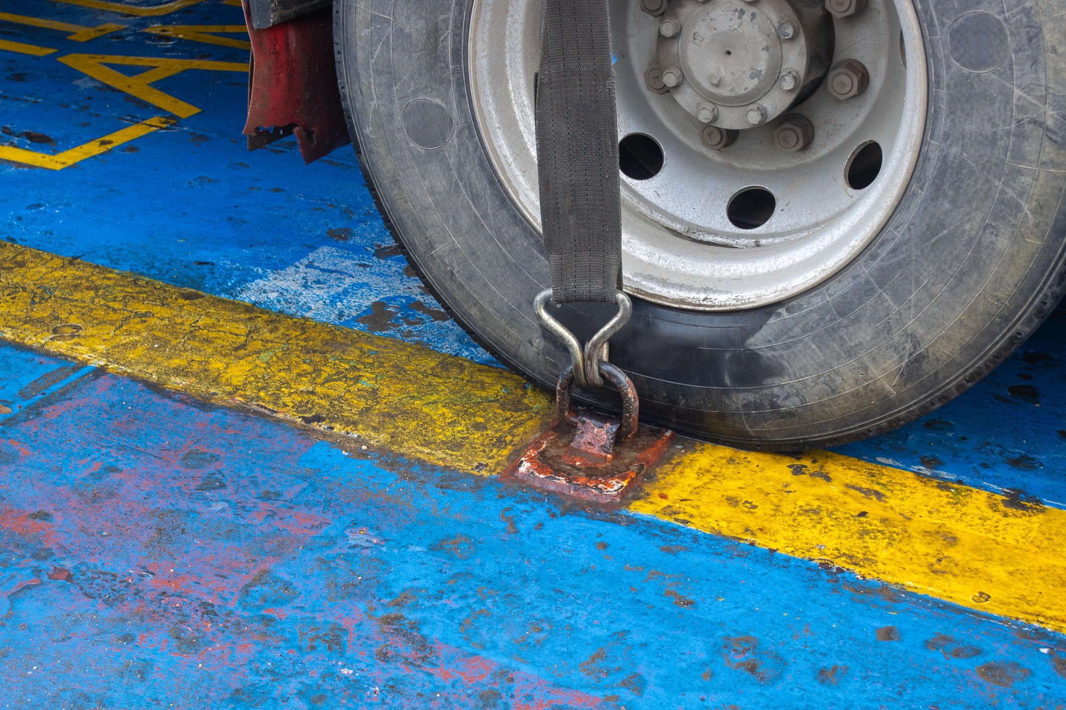 Safety straps securing a vehicle wheel for transport